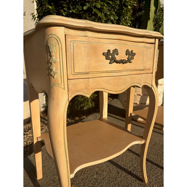 Pair of vintage French Provincial style nightstands in solid wood, likely oak, with a light natural finish. Each features...