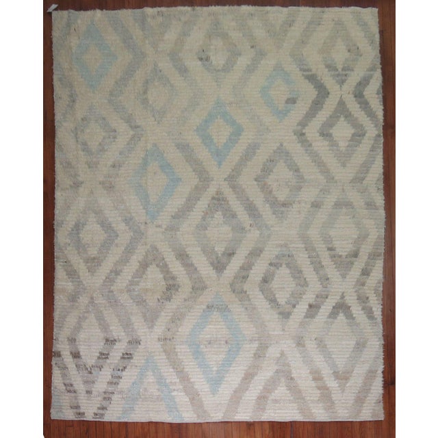Contemporary Old wool Turkish Tulu in faded creams, gray and light blues. Measures: 8'3'' x 11'6''.
