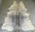 Stunning large natural Brazilian cowhide in variegated shades of gray with gold metallic spatters. The contrast against...