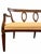 An antique mahogany settee with ornately by carved openwork patterned back and off-white striped upholstery.