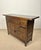 Mid 20th century Spanish rustic commode crafted in solid wood with a warm aged patina. The piece features a single upper...