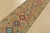 A tribal Caucasian Kazak runner hand-knotted with fine wool on a cotton foundation. This rug features a row of geometric...
