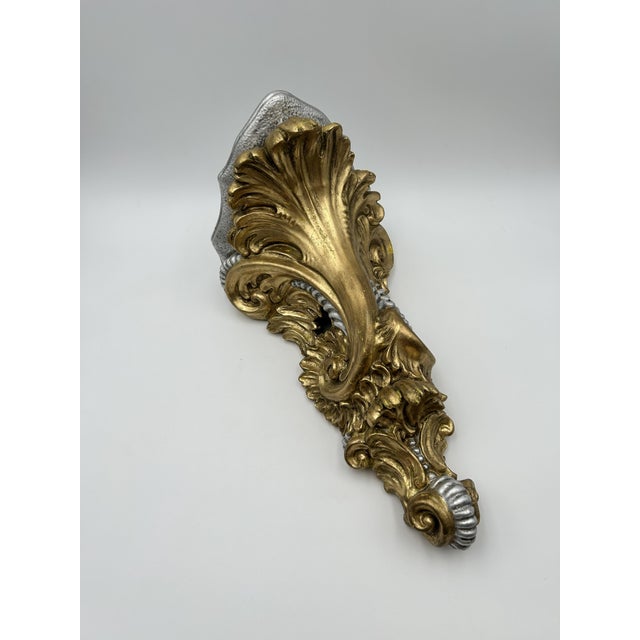 Pair (2) of decorative wall sconce shelves with ornate gold scrollwork. Each sconce shelf measures: - 9.25" W x 10" D x 18" H
