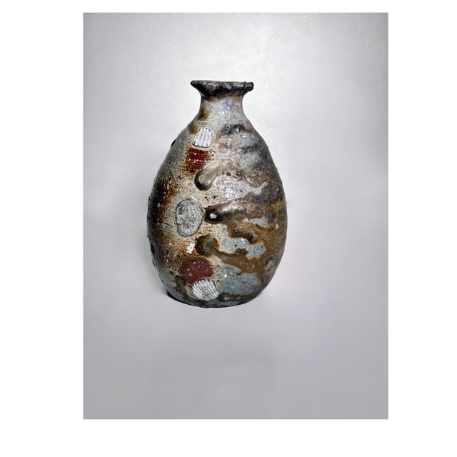 A richly expressive vintage studio pottery bud vase, distinguished by its organic form and textural surface. Hand-thrown...