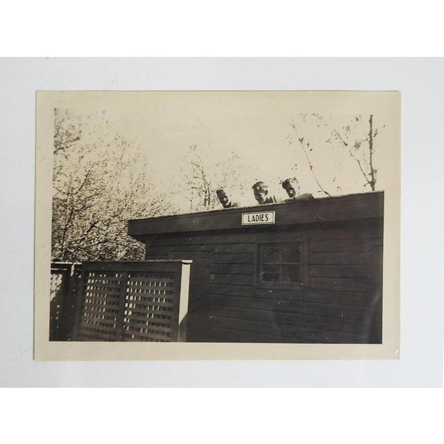 Early 20th century sepia snapshot photograph of boys on the roof of a ladies room. Unframed.