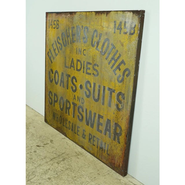 Reclaimed movie set sign made of aluminum in yellow and gray. The sign reads "145B, Fleischer's Clothes Inc., Ladies,...