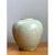 This vase presents a soft, rounded silhouette rooted firmly in classical Asian ceramic tradition, its body swelling...