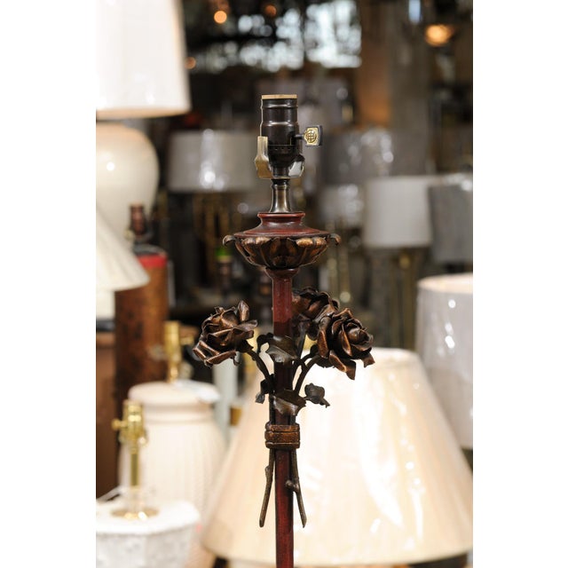 A truly stunning pair of gilt and painted Italian tole floor lamps from the 1940s. The deep garnet lacquered finish is...