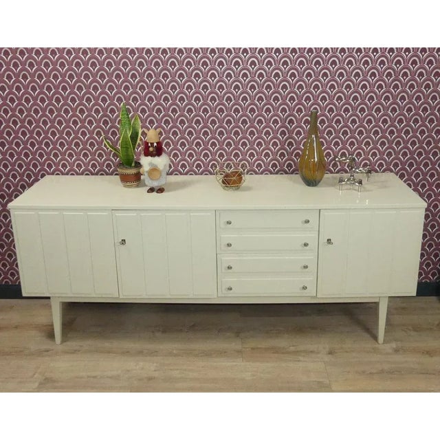 XL sideboard! Compact and sturdy. Typical of the Panton era in cream white. Timelessly stylish. Four drawers, three...