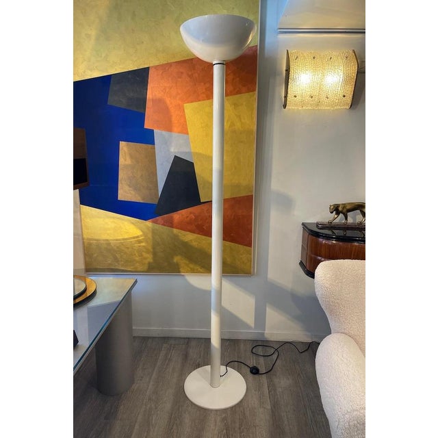 LUCE floor lamp from the 1970s, crafted in white enameled metal. The lamp can be adjusted in two positions: directed...