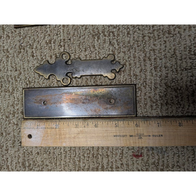 Vintage 12-piece furniture hardware set featuring six rectangular drawer backplates and six ornate escutcheon-style pull...