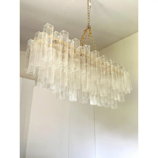 Scenographic italian hand-made chandelier with transparent "square", elements of murano glass in a lively movement. huge...