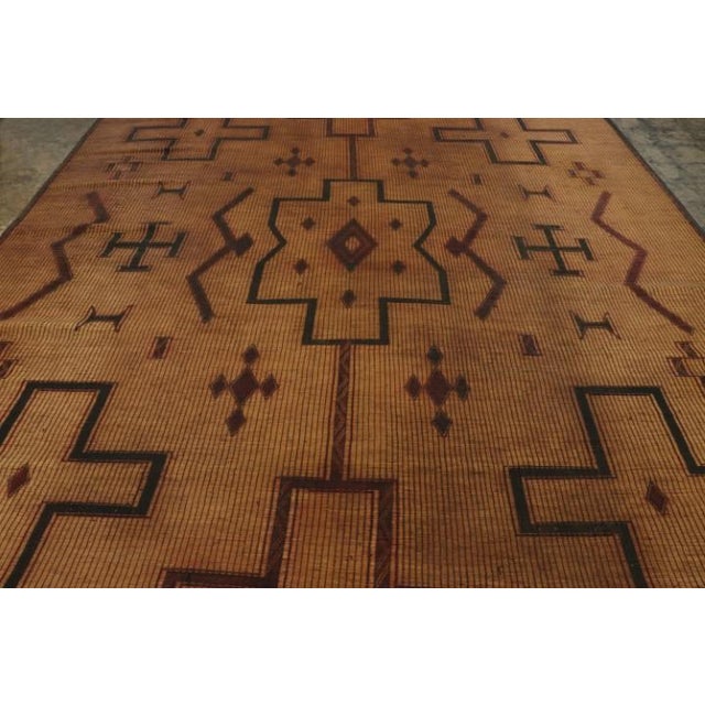 Made with handwoven reed and camel leather in Mauritania circa 1950-1960, this 10x13 vintage Tuarage mat is an exceptional...