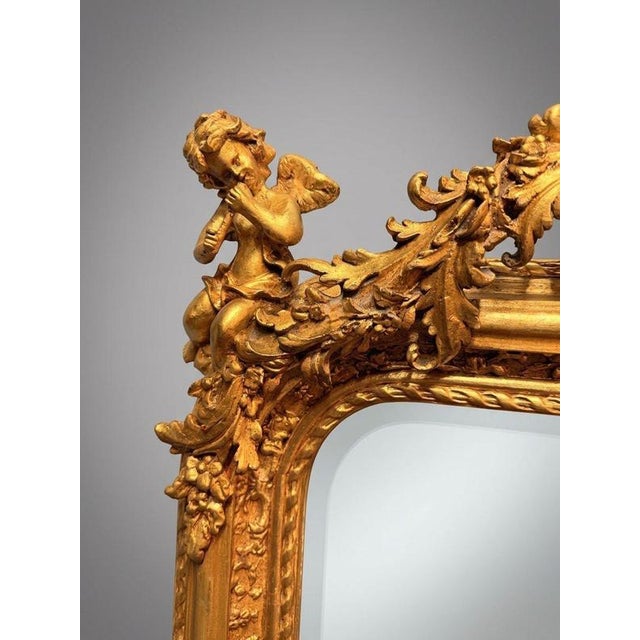 An absolutely stunning French-inspired panel mirror featuring a rich gilt wood and plaster frame with beveled glass. The...