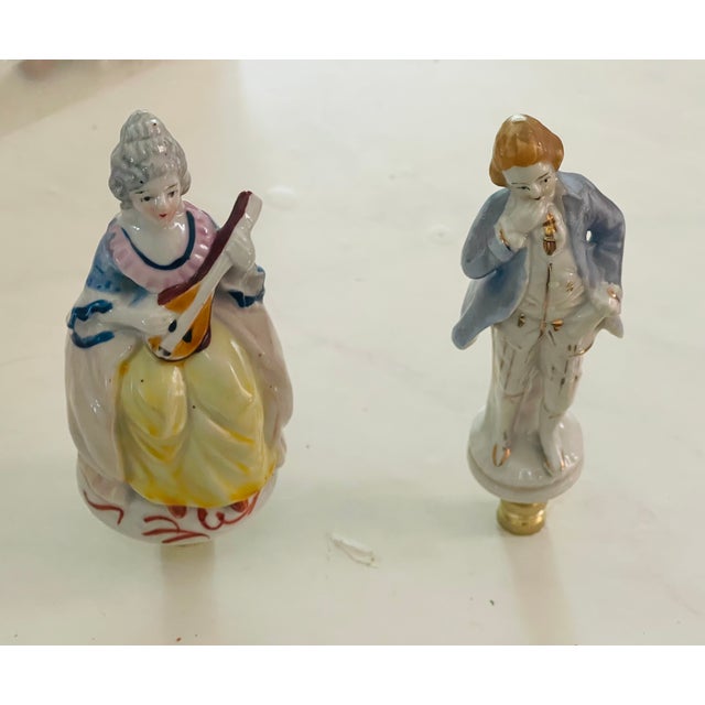 Lovely Victorian couple of musicians porcelain figurines in period clothing, mounted on brass bases as lamp finials.