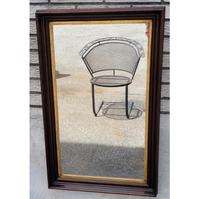 Elegant 19th-century American Federal Style wall mirror crafted in solid walnut with its original gold gilt inner trim....