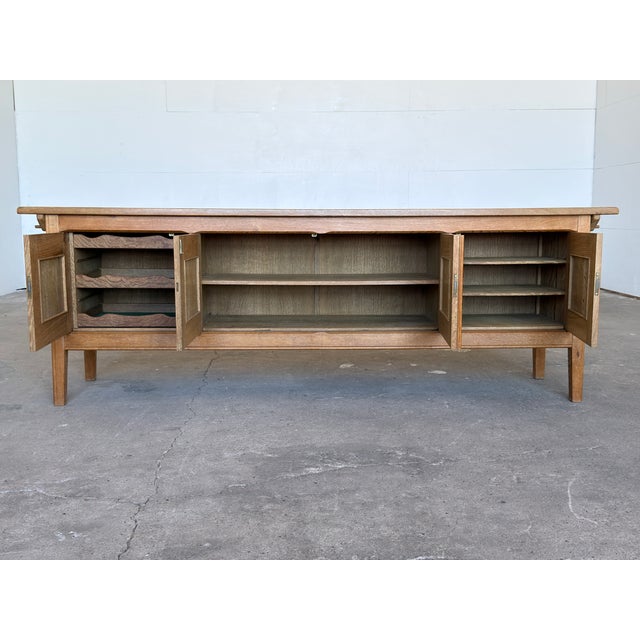 A Danish oak sideboard credenza by Henning Kjærnulf, produced in Denmark during the 1960s. Constructed throughout in pale,...