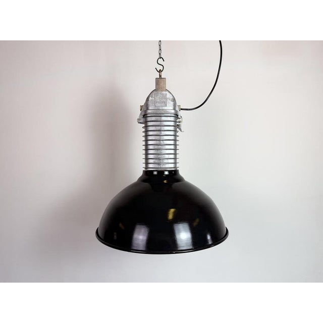 Industrial black enamel factory pendant light made by philips in netherlands during the 1960s. White enamel inside the...