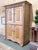 A remarkable antique English pine cupboard showcasing the honest character and enduring craftsmanship of traditional...