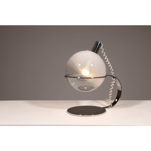 Discover the elegance of mid-century design with this exquisite Italian table lamp, crafted from chrome with a hand-blown...