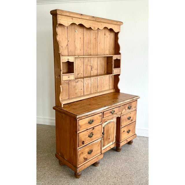 This magnificent antique-inspired Welsh dresser is a triumph of primitive craftsmanship, perfectly capturing the rustic...