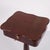 Antique sewing table / lamp table crafted in mahogany with a column base, three feet, and a lock. Dating from the 20th...