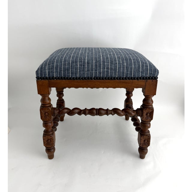 This French 1920s Jacobean / Louis XIII Revival upholstered stool features an expertly carved solid wood base. The antique...