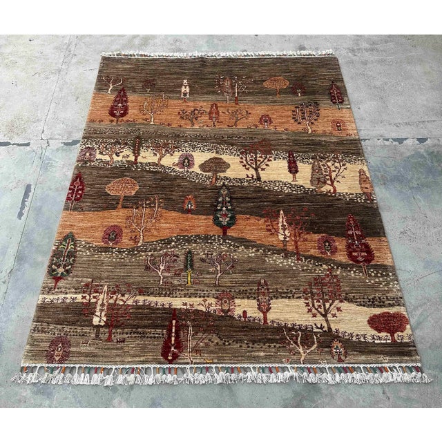 Description: Transform your space with this Vintage Persian Gabbeh Wool Landscape Rug, a handwoven piece that feels like...