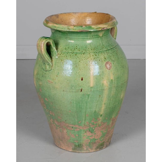 A large 19th century green glazed terracotta pottery olive jar from the Southwest of France. Minor losses to glaze and...