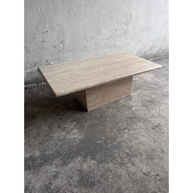 A timeless italian coffee table crafted from solid travertine, dating from the 1970s. Defined by its clean architectural...