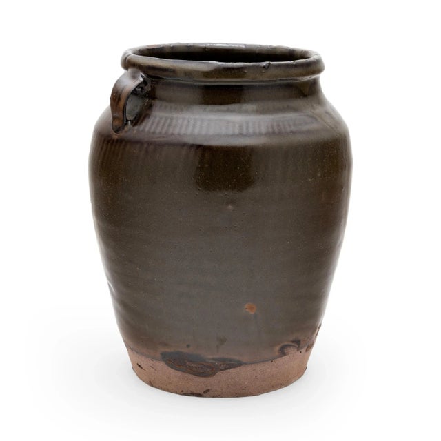 Originally used to store foods or pickle vegetables in a provincial Chinese kitchen, this late 19th-century ceramic jar is...