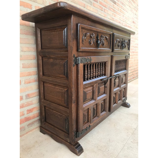 About From Northern Spain, constructed of solid walnut, the rectangular top with molded edge atop a conforming case...