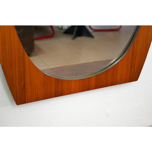 Oval mirror made by La Permanente Mobili Cantù in the 60s in teak and plywood. At the moment it is presented vertically,...