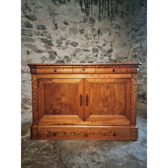 This elegant french sideboard was crafted during the louis philippe period in the mid-19th century. made from solid elm...