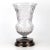 Crystal vase with a flower design on a silver rim.