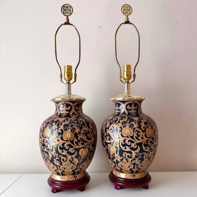 Vintage pair of cobalt blue and gold filigree porcelain table lamps with brass accents. The pair of lamps almost appear...