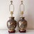 Vintage pair of cobalt blue and gold filigree porcelain table lamps with brass accents. The pair of lamps almost appear...
