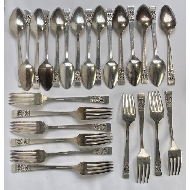A collection of 26 odd pieces includes: Fifteen Spoons ~ 1.25”W x 6”D x .75”H each Seven Dinner Forks ~ 1”W x 7.25”D x...