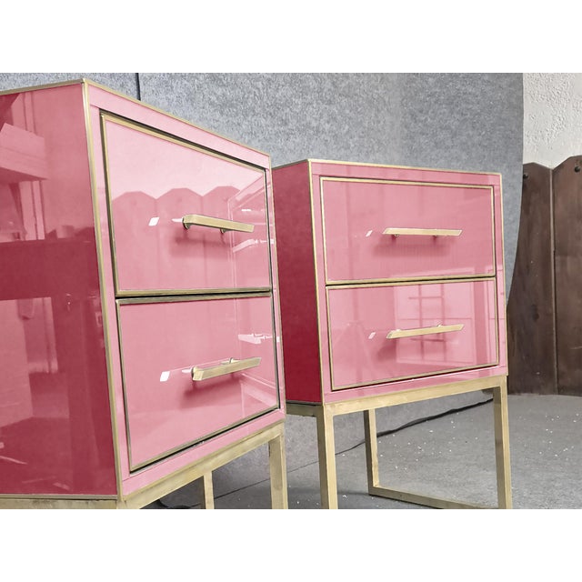 These luxury bedside tables in pink Murano glass and brass exemplify exquisite Italian craftsmanship and Mid-Century...