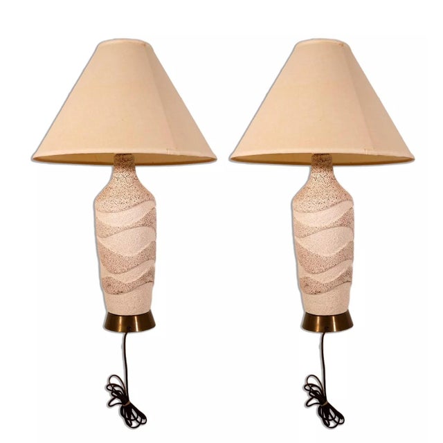 Warm and inviting, this pair of Waved Textured Ceramic Lamps is the quintessence of Mid-Century Modern charm. The unique...