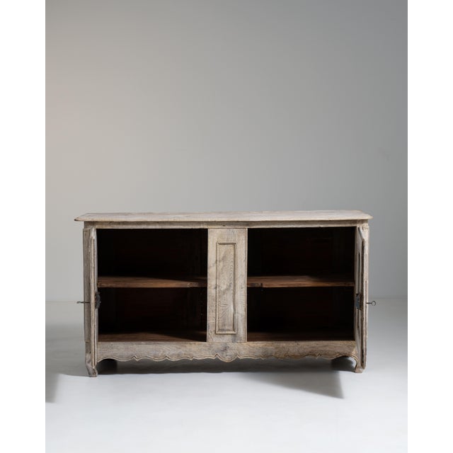 A classic Louis XV buffet embodying the Rococo period’s emphasis on movement and elegance, visible in the curved façade...