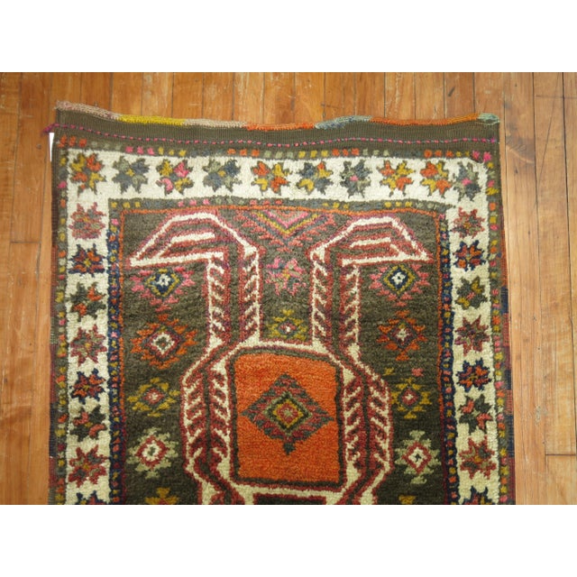 Mid 20th century tribal Turkish Anatolian runner with a tribal design in brown, orange, pink and ivory dominant accents...