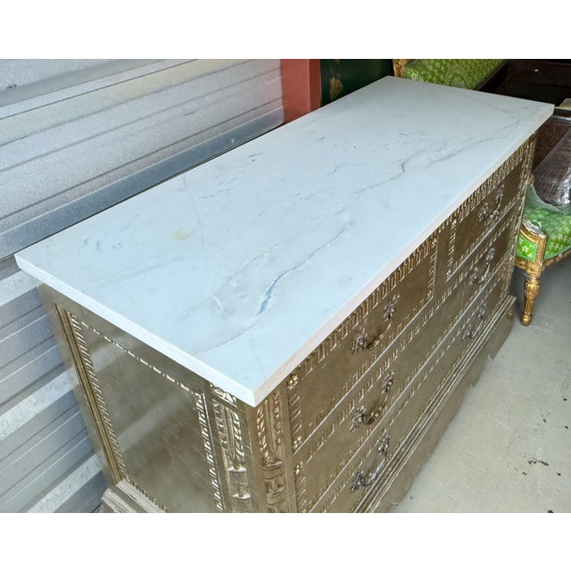 This is a late 20th-C. Silver leaf chest with French Louis XVI styling. It has a beautiful carrera honed marble top. The...