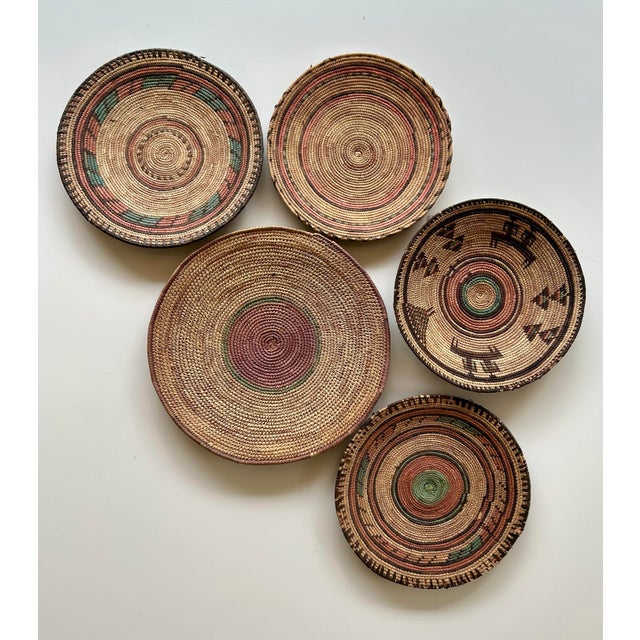 Boho chic style, set of five tightly coiled and stitched with natural grass fibers. Geometric patterns featuring brown,...