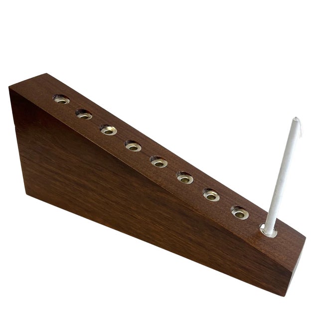 This contemporary menorah is handcrafted from solid walnut, celebrating the natural richness and warmth of American...