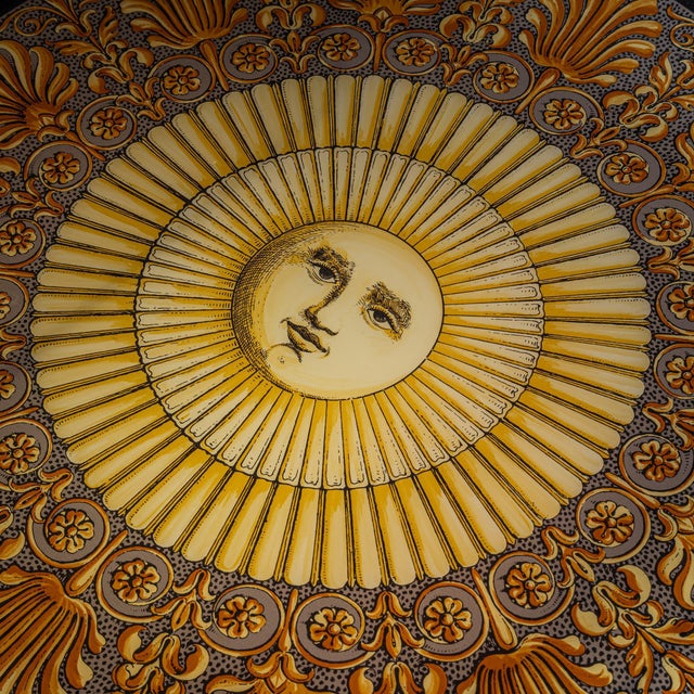Large square coffee table by Fornasetti featuring the iconic sun motif and a subtly wavy perspex tabletop set on an iron...
