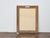 Dating to circa 1920, this French giltwood mirror features a crisply carved spiral frame set against a pale wood surround....