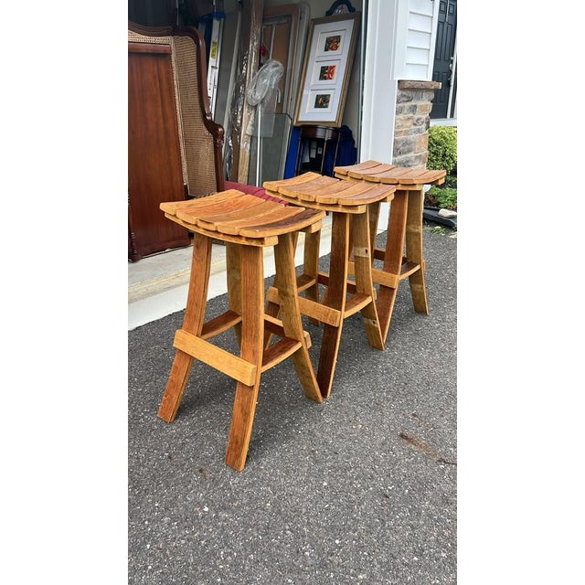Set of 3 custom handmade wooden bar stools crafted from curved oak barrel staves. Solid construction with curved saddle...