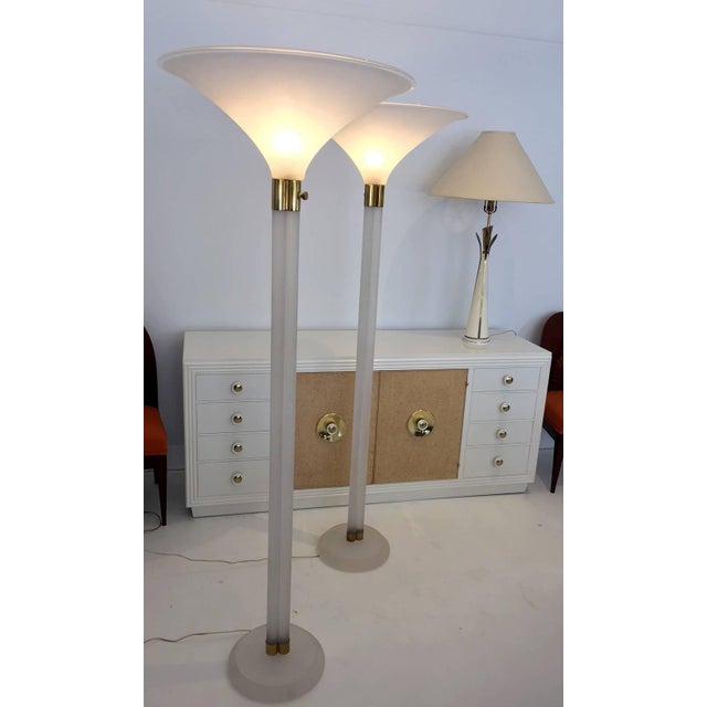 A stunning pair of monumental torchiere floor lamps. These oversized lamps were designed by Karl Springer for Karl...