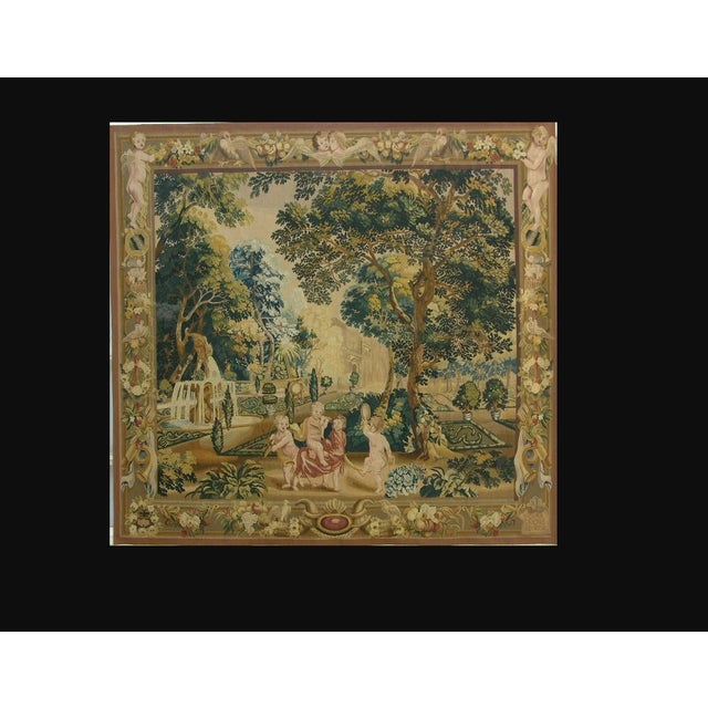 This vintage European-style tapestry wall hanging presents an elaborate formal garden scene inspired by the long...